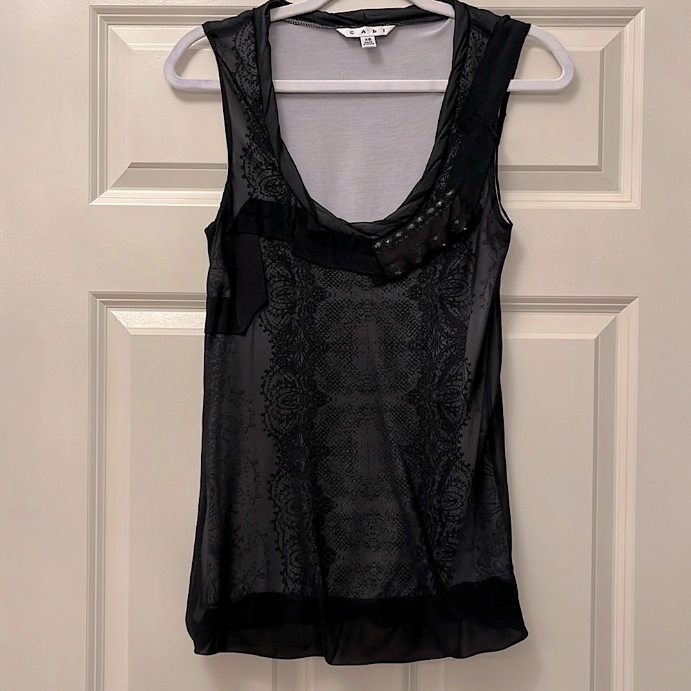 Cabi top. Sleeveless with deep twist neckline. Jewel detail